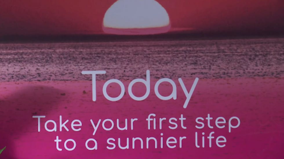 motivational text against a sunset background