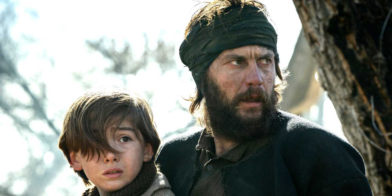 Devin (Preston Mota) and Isaac (Taylor Kitsch) looking worried in American Primeval