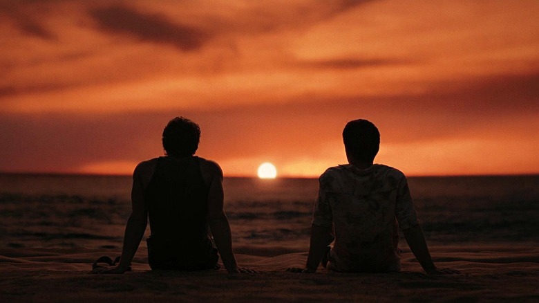 Shane Hollander and Ilya Grigoryevich Rozanov, watching a sunset on a beach in Heated Rivalry.