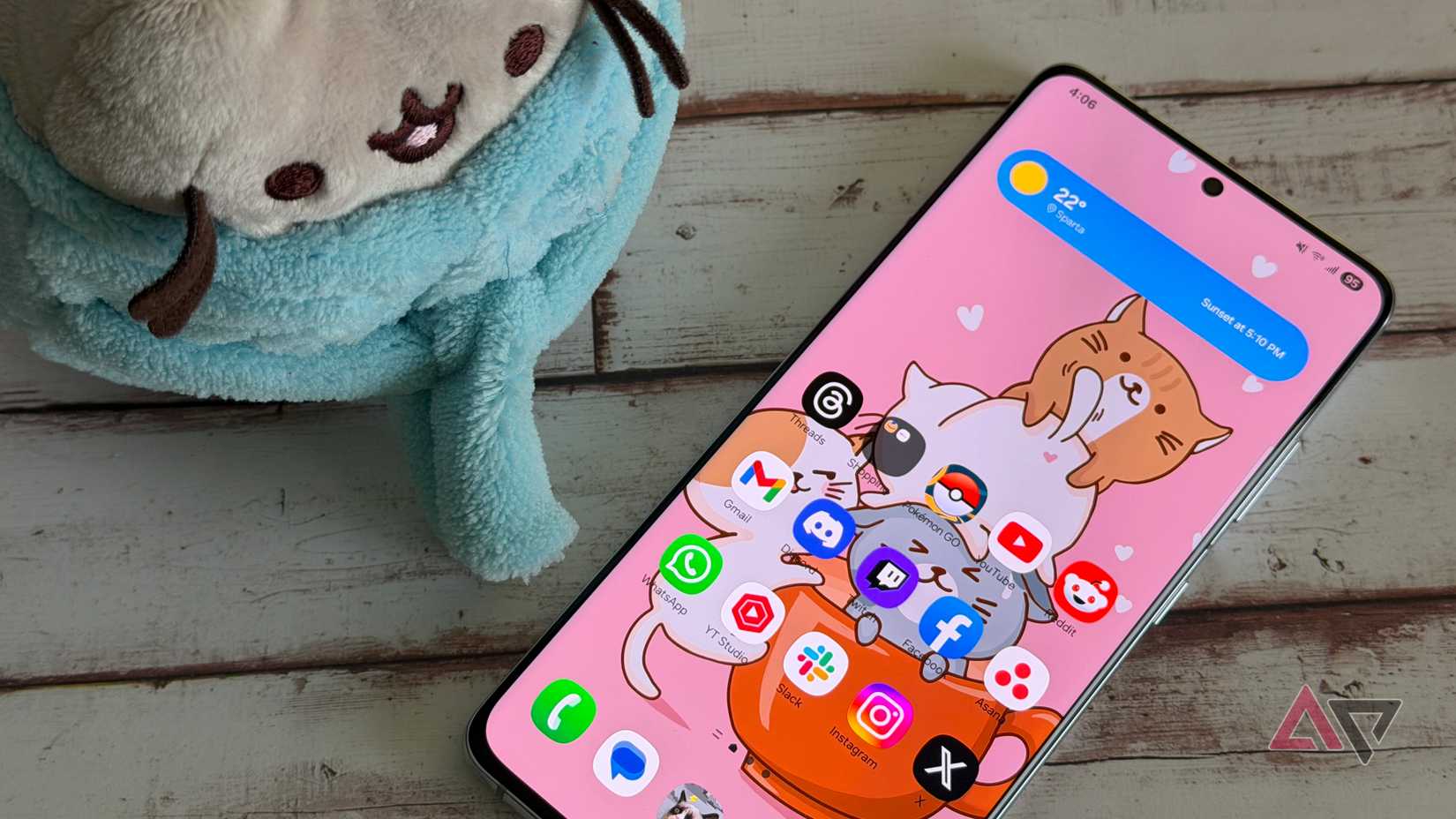 Samsung Galaxy S21 Ultra next to a plush with the home screen displayed