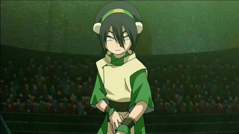 Toph standing in the earthbending ring in 