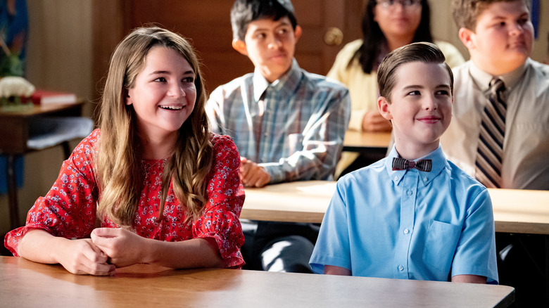 Missy and Sheldon Cooper sitting together in class on Young Sheldon.