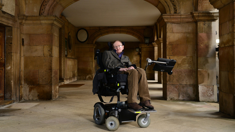 Stephen Hawking sits in his famous speech-enabled wheelchair in the halls of University of Cambridge's Emmanuel college.