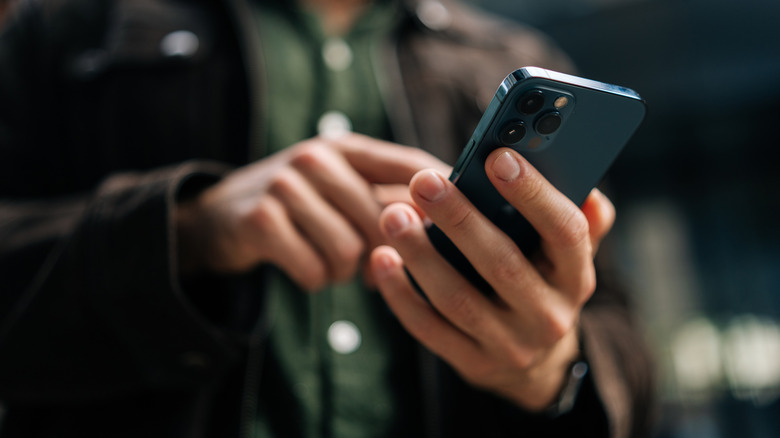 Close-up of a man holding a smartphone