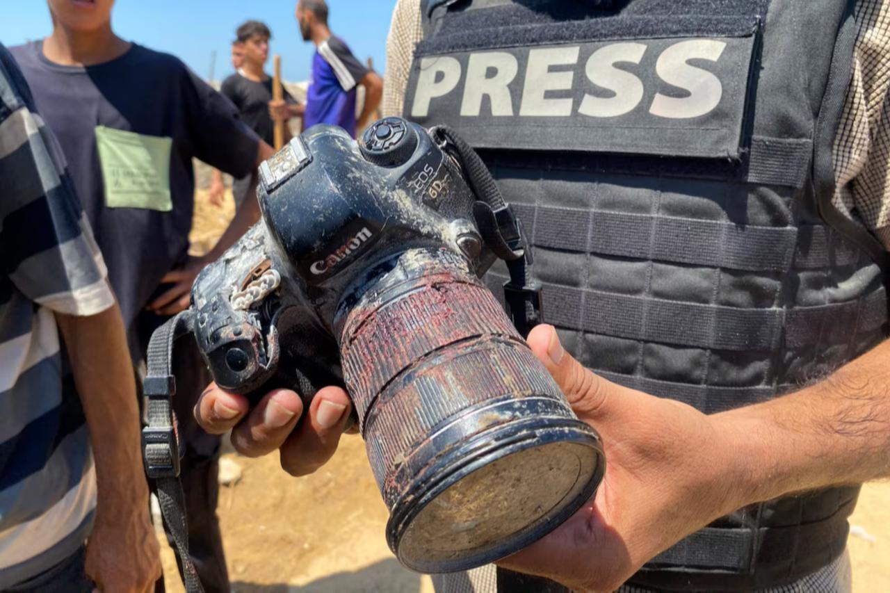 A journalist holds the blood-covered camera belonging Mariam Dagga, a Palestinian photojournalist killed in an Israeli strike on Nasser hospital in Khan Yunis in the southern Gaza Strip on August 25, 2025. (AFP Photo)