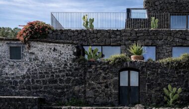 lava stone and fisherman's house merge into villa on sicilian coast