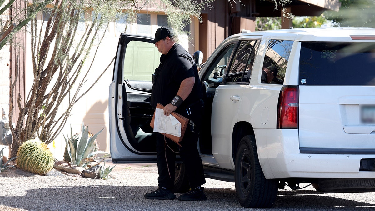 Law enforcement officers on the grounds of Annie Guthrie's property in Tucson.
