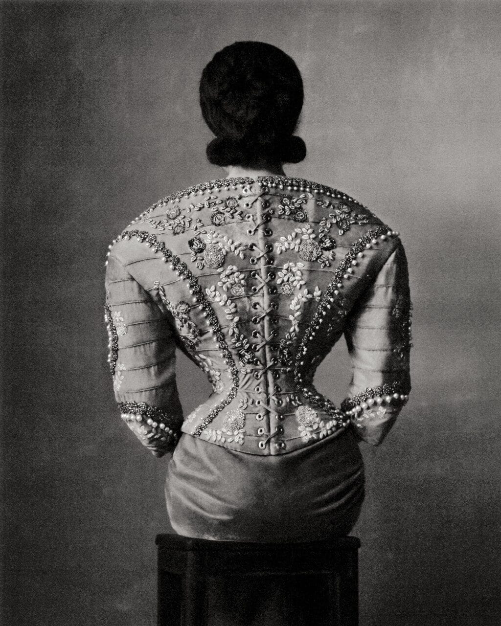 an editorial portrait by Szilveszter Makó of the backside of a woman wearing a Schiaparelli garment, emphasizing an exaggerated silhouette.