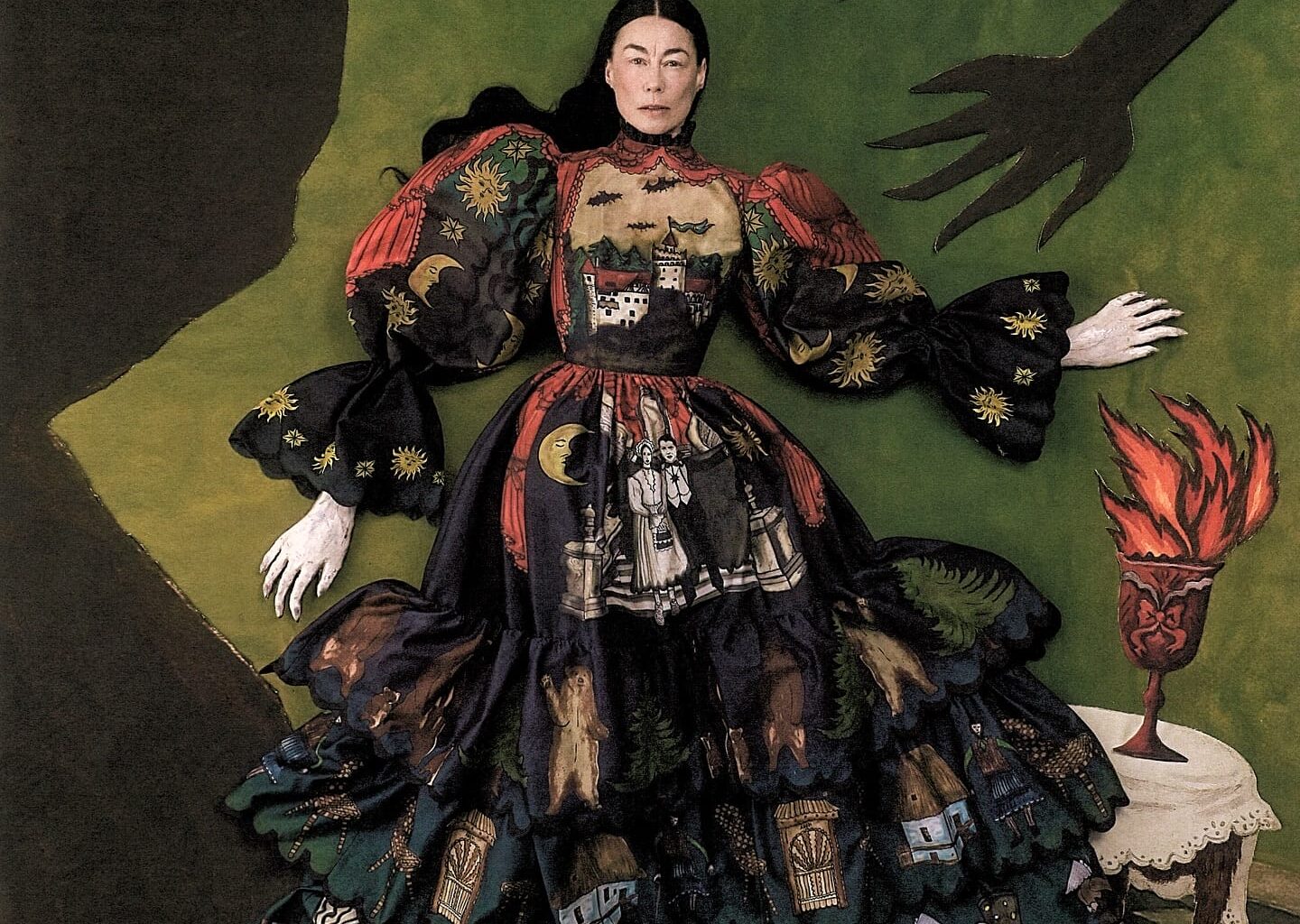 an editorial flat-lay portrait by Szilveszter Makó of a woman in an ornate gown. the background consists of a checkered floor and two dimensional silhouettes of a man and arms reaching for her