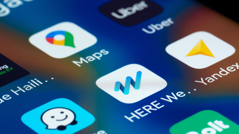 A close-up view of a smartphone screen displaying popular navigation and mobility apps.