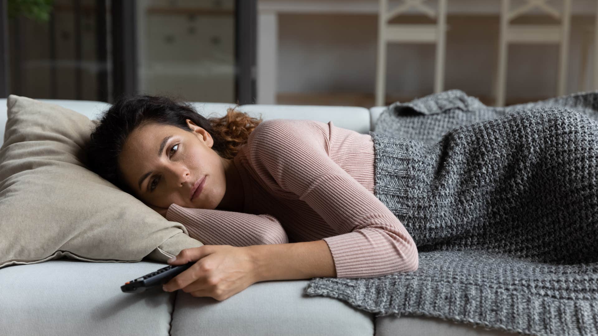 Tired millennial watching TV showing source of stress