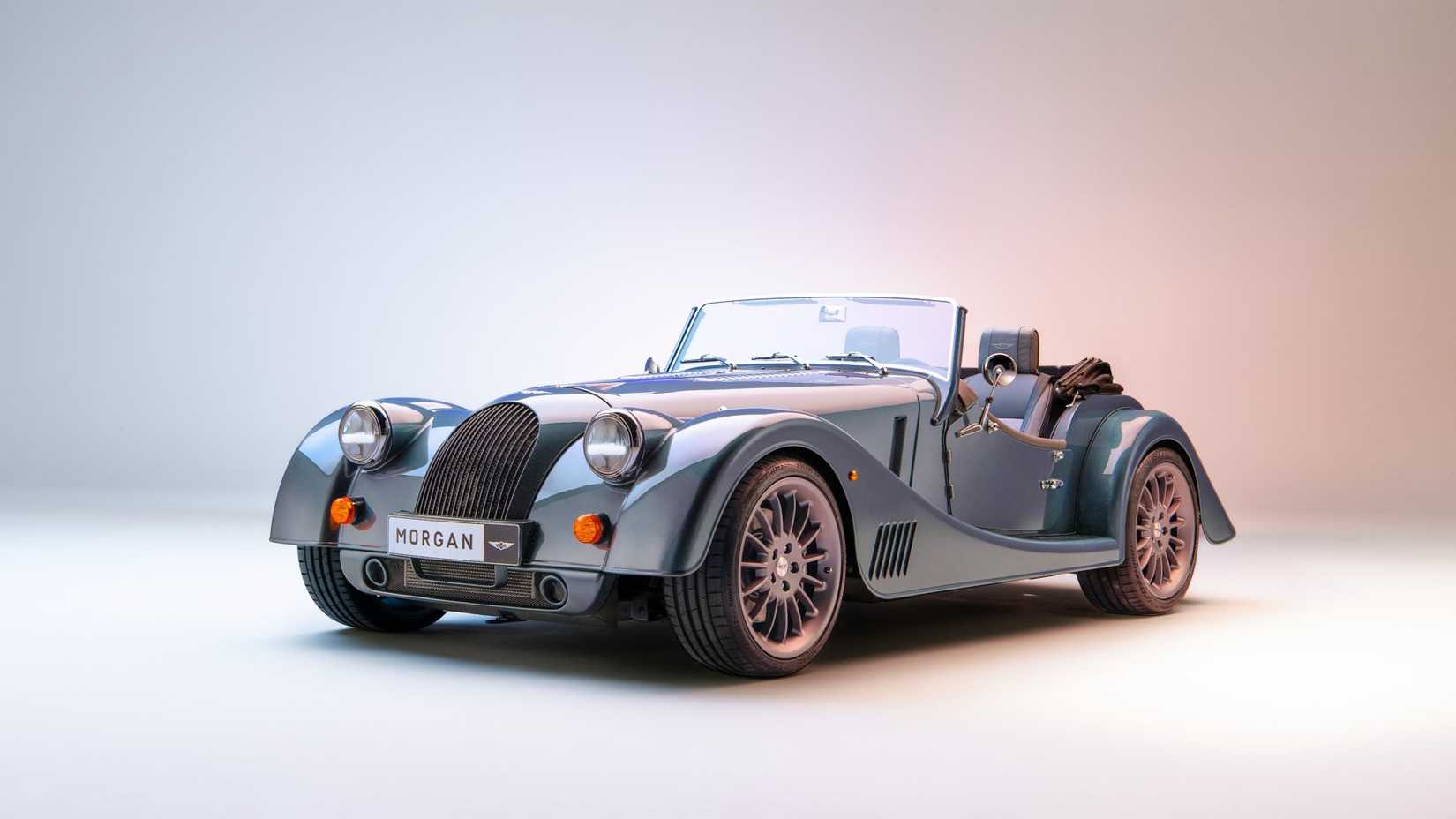A Light blue 2023 Morgan Plus Six in a studio