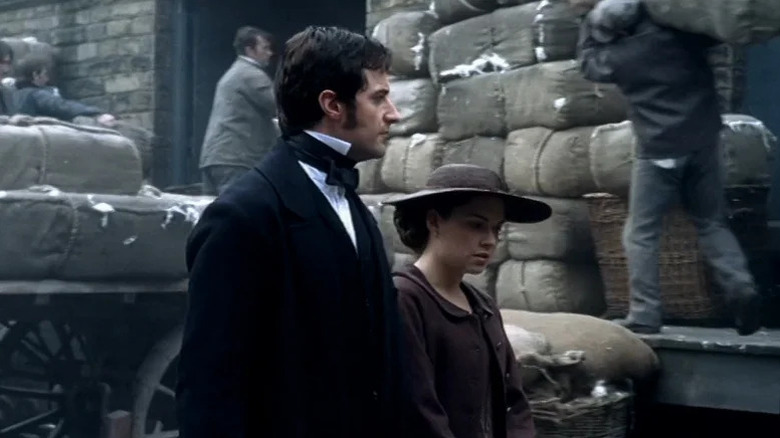 John Thornton (Richard Armitage) walks with Margaret Hale (Daniela Denby-Ashe) by a busy platform in North & South