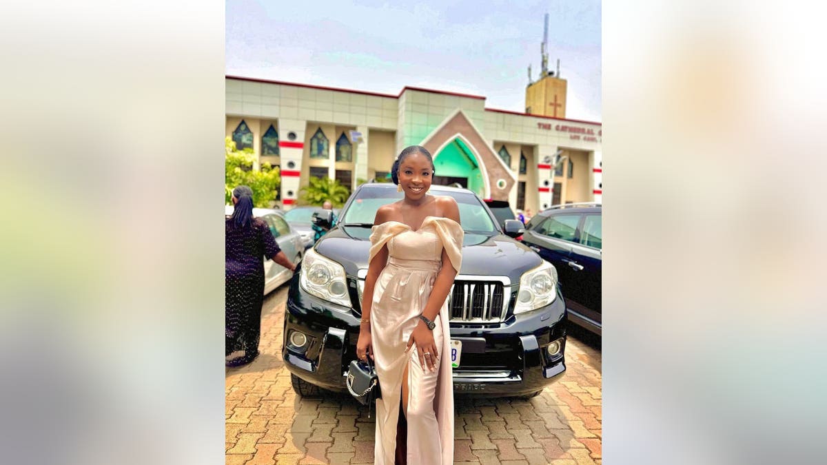 Ifunanya Nwangene smiling next to a car
