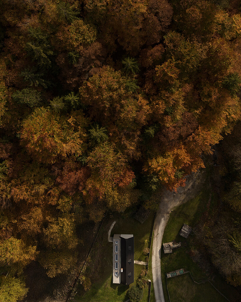 farmhouse and modern extension face off in austrian hillscape
