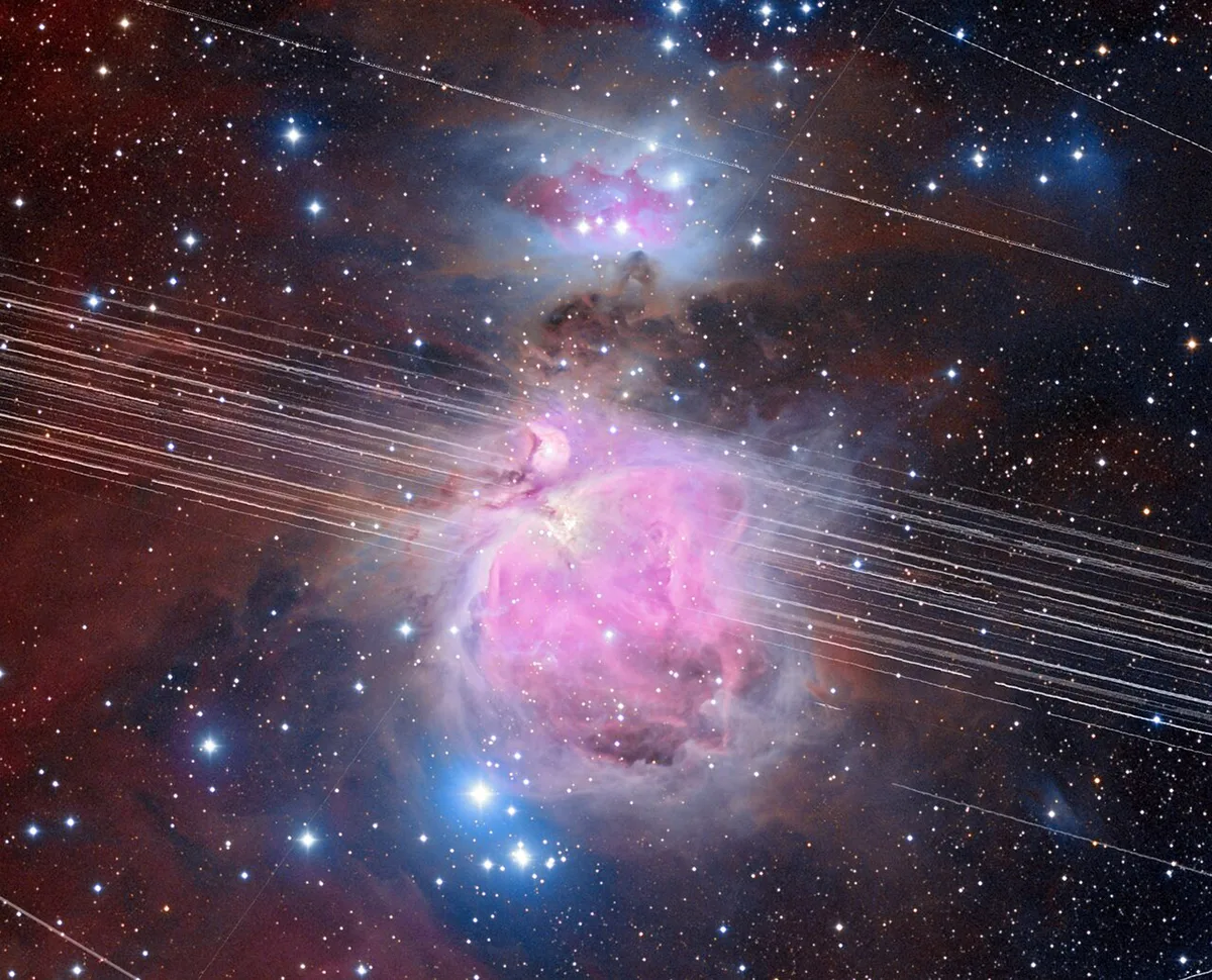 This long-exposure image of the Orion Nebula lasted 208 minutes. In that time, multiple satellite trails streaked across the night sky. Credit: A. H. Abolfath/NOIRLab/NSF/AURA