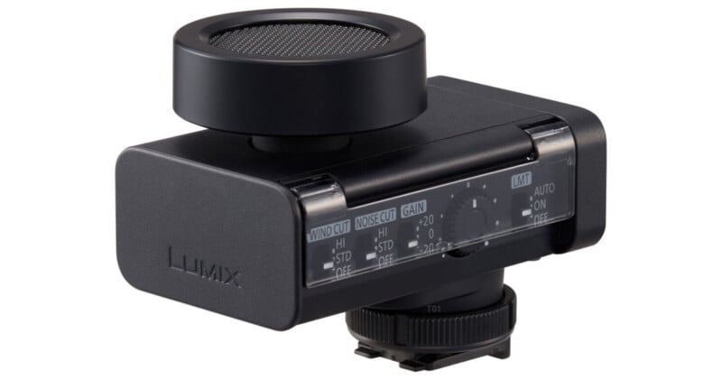 A black Lumix camera microphone with control dials and labeled settings for wind cut, noise cut, and gain, mounted on a camera shoe adapter.