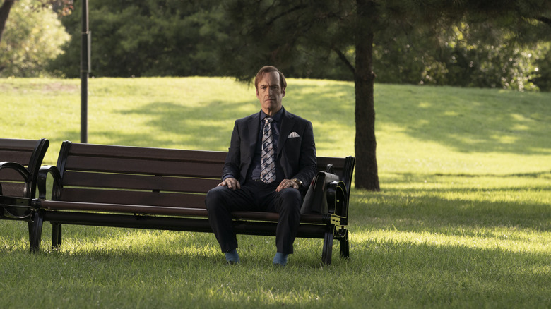 Jimmy McGill, sitting alone on a park bench in Better Call Saul.