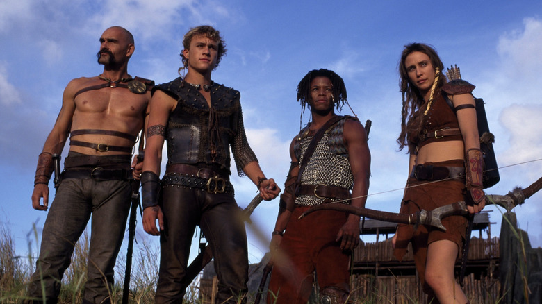 Fergus, Conor, Tully and Caitlin standing in grassy field in ancient clothing in Roar