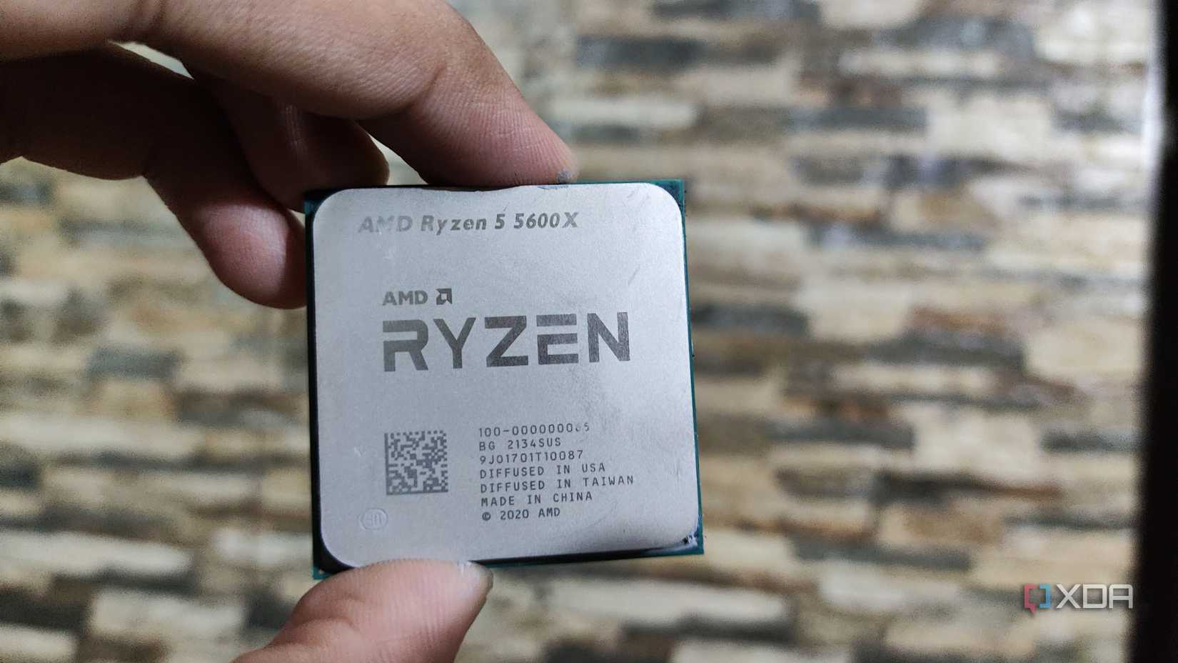A person holding a Ryzen 5 5600X