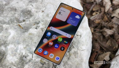 The Samsung Galaxy S25 Ultra laying outside with its display on.