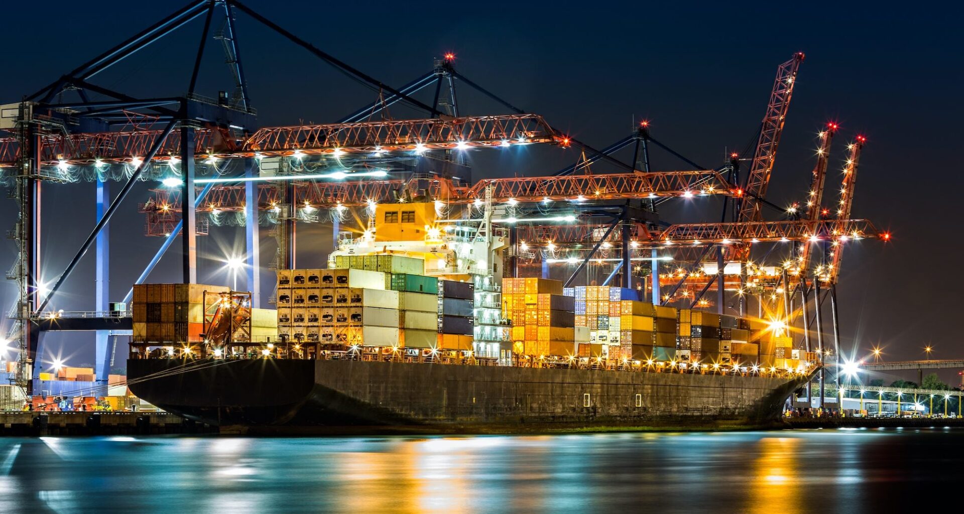 A containership being loaded at the Port of New York and New Jersey at night.