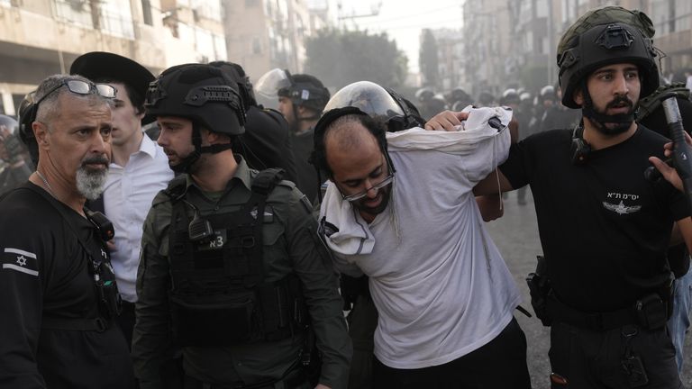 Israeli police detain a man during the protest. Pic: AP