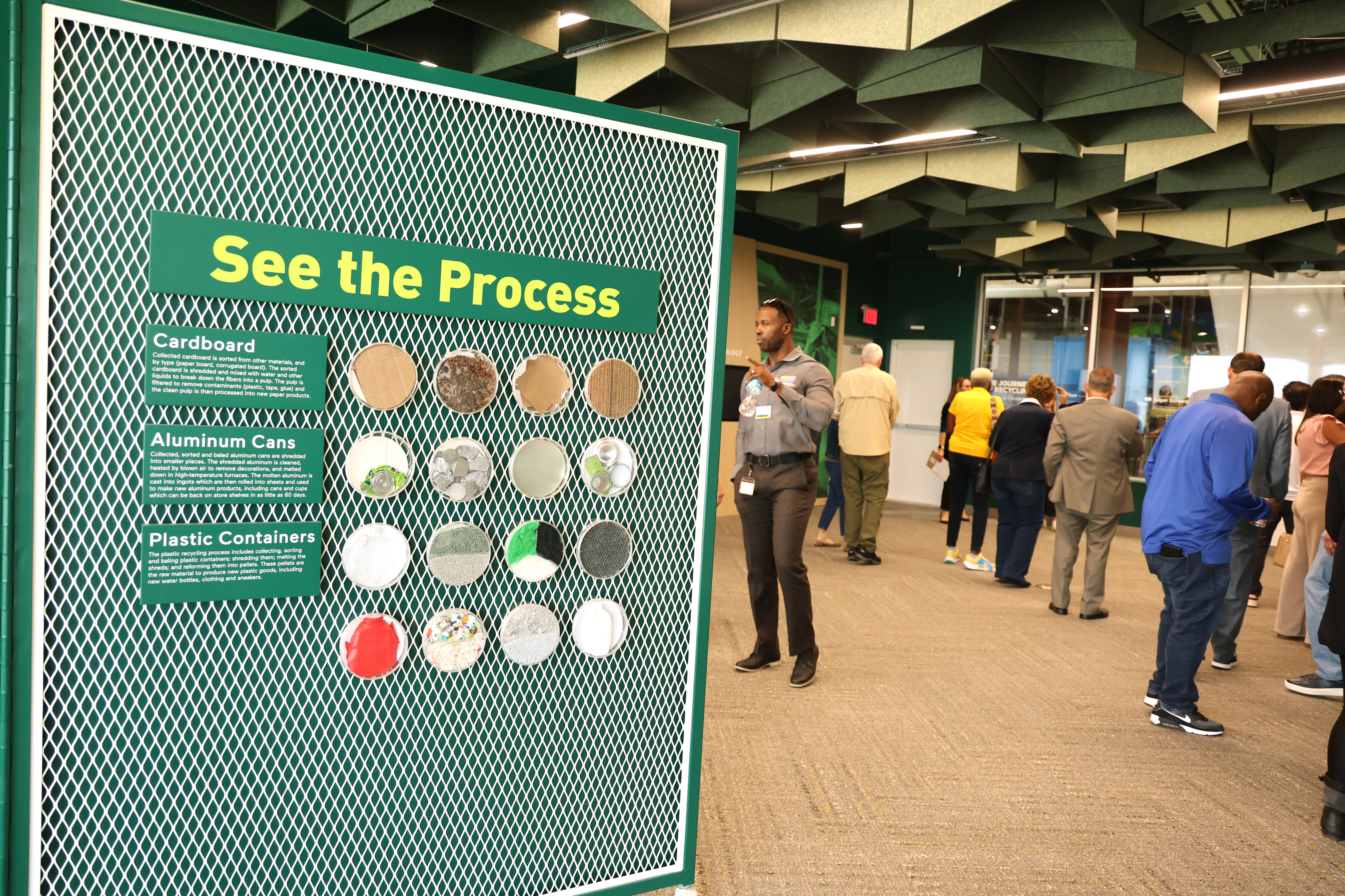 People during a tour of Waste Management Recycling South Florida facility in Pembroke Pines on Thursday, February 19, 2026. The facility's education room includes displays detailing the recycling process. (Carline Jean/South Florida Sun Sentinel).