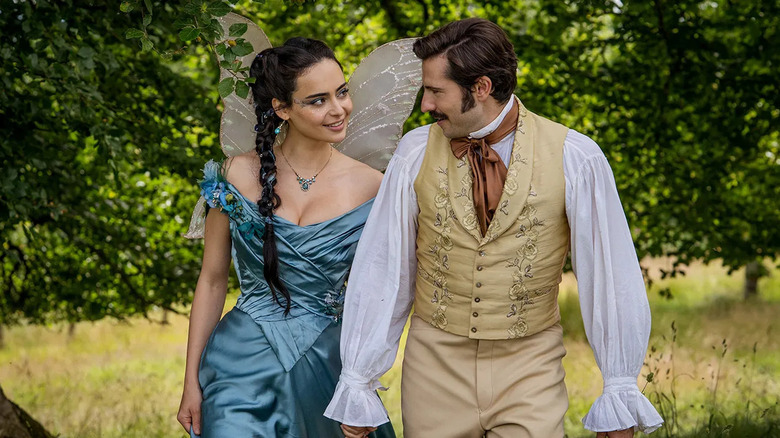 Lizzy Elmsworth (Aubri Ibrag) strolls through a forest smiling at Theodore (Guy Remmers) in The Buccaneers