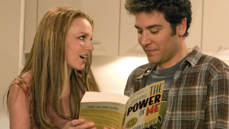 Abby holds a book while fawning over Ted Mosby in 
