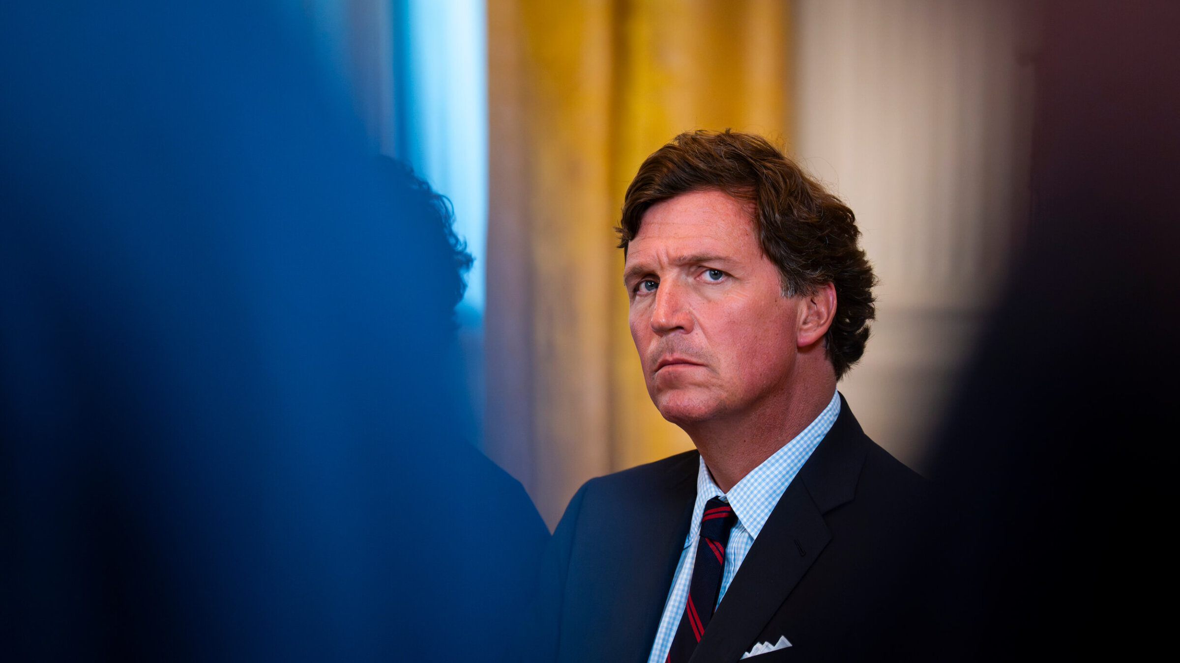 Tucker Carlson attends a meeting in the East Room of the White House on Jan. 9.
