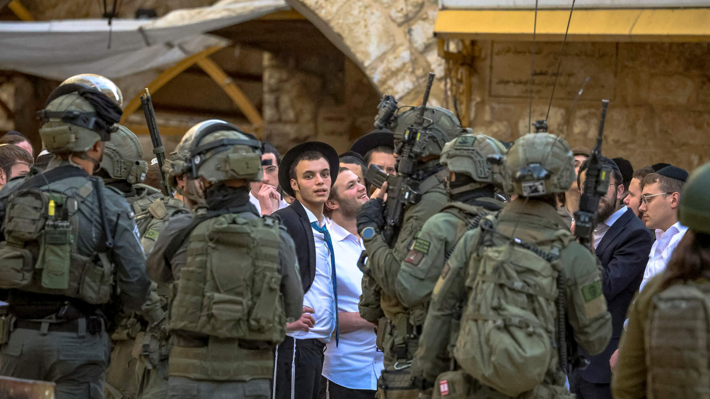 Israeli soldiers escort Israeli settlers as they walk through the Old City of Hebron in the occupied West Bank on Jan. 30.