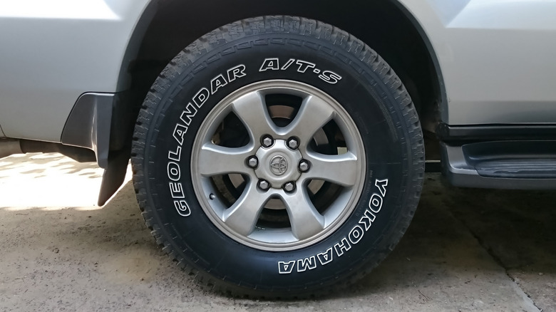 A close-up of a Toyota Tundra wearing a Yokohama all-terrain tire on its rear right corner.