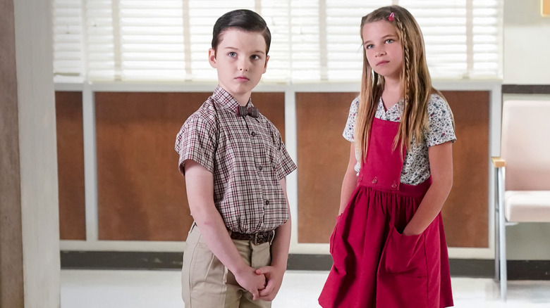 Sheldon and Missy Cooper standing in the school hallway together on Young Sheldon.