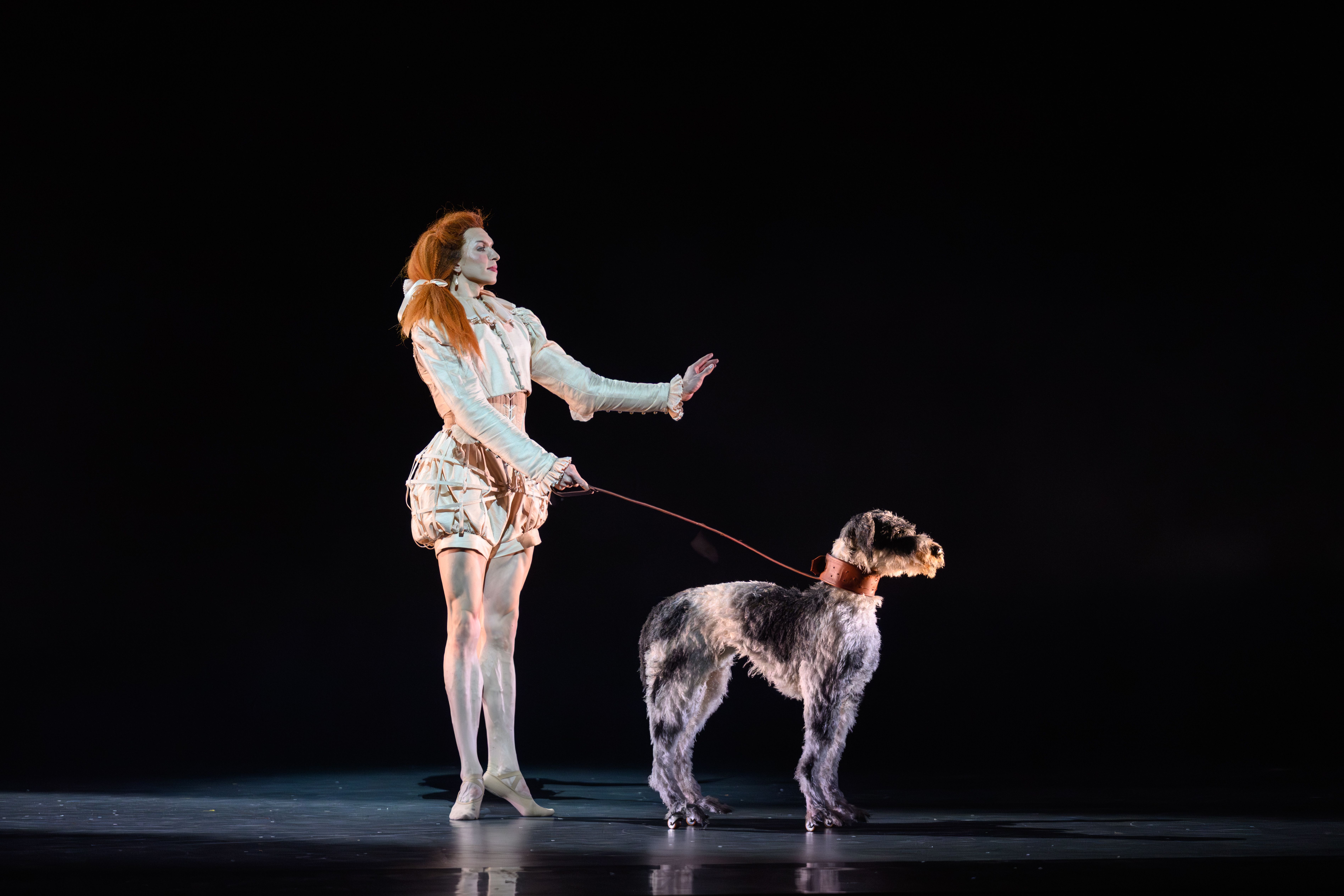 Roseanna Leney as Mary, Queen of Scots, with a prop dog in the Scottish Ballet production of "Mary, Queen of Scots."