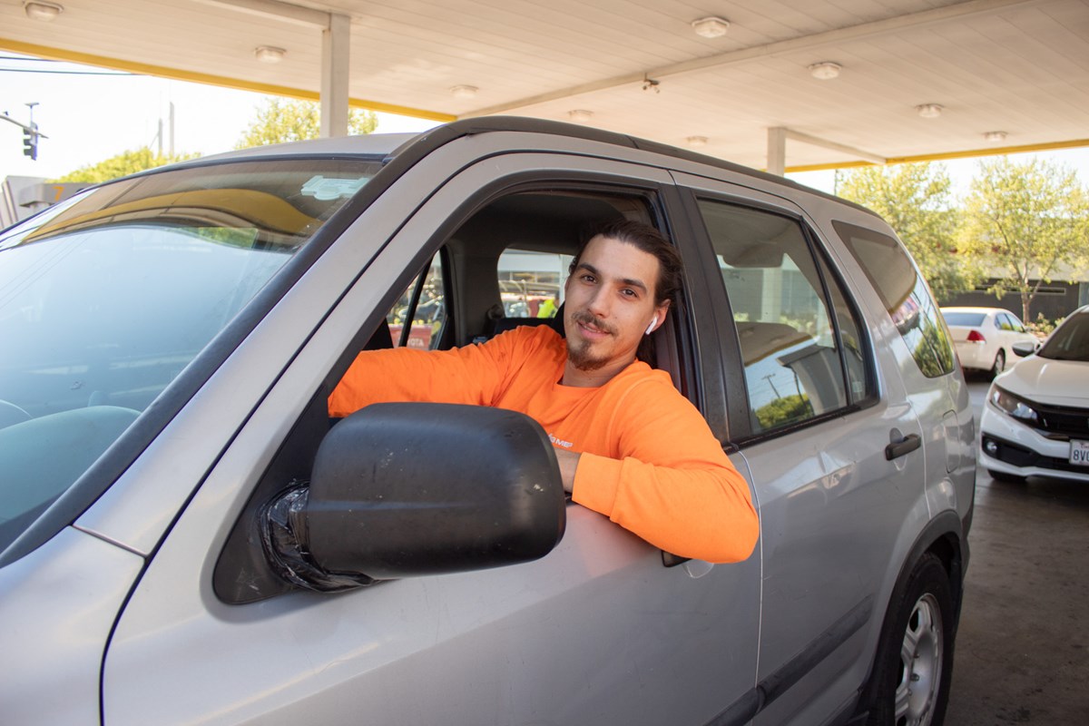 James Delaney, 31, sits in his Honda CR-V after filling up his gas tank Friday, March 20, 2026, in Sacramento.