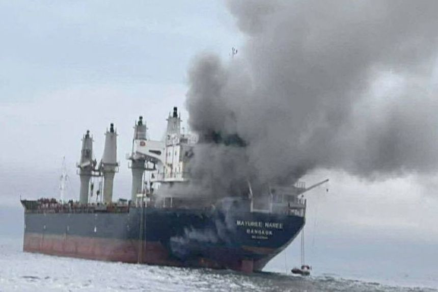 The Thailand-flagged cargo ship Mayuree Naree is engulfed in black smoke in the Strait of Hormuz, on March 11.