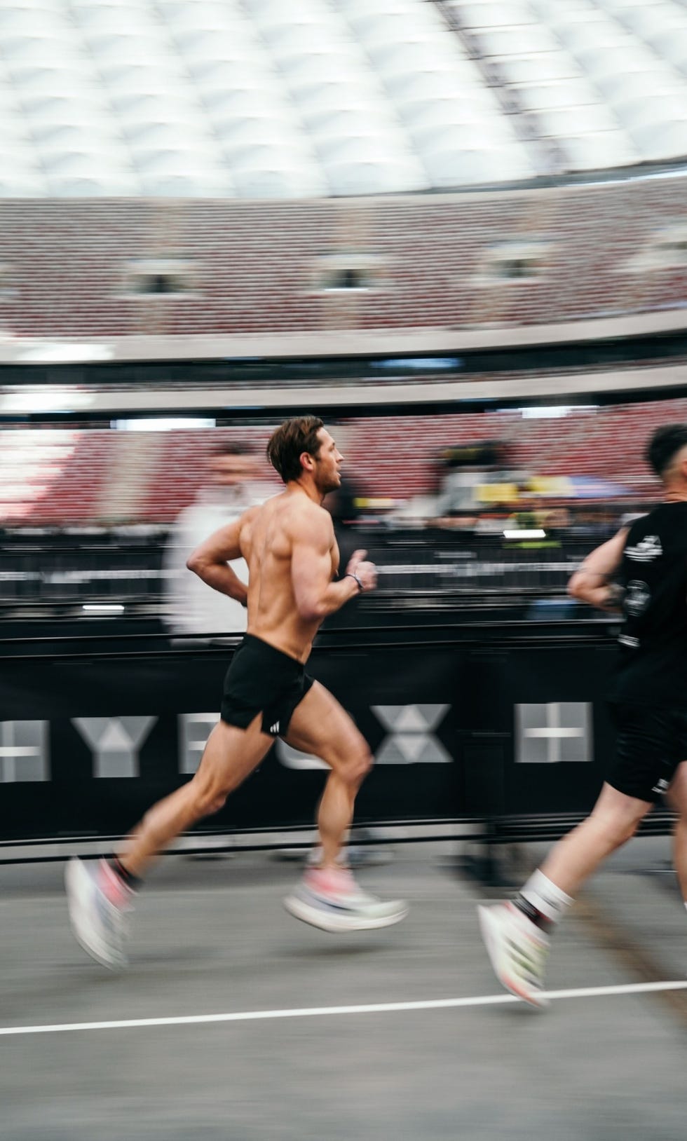 runners competing in a race within a stadium