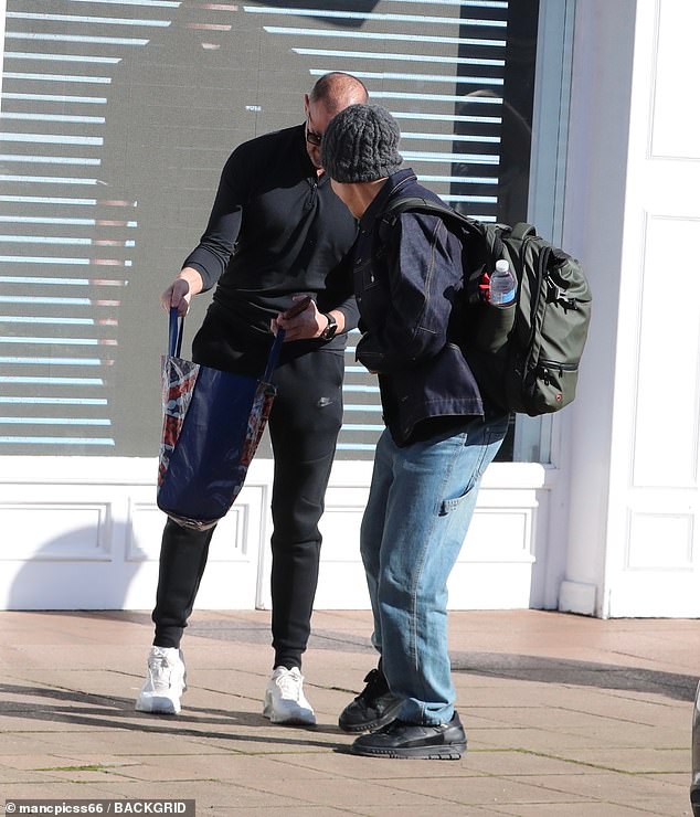 He was snapped showing someone what was inside his bag