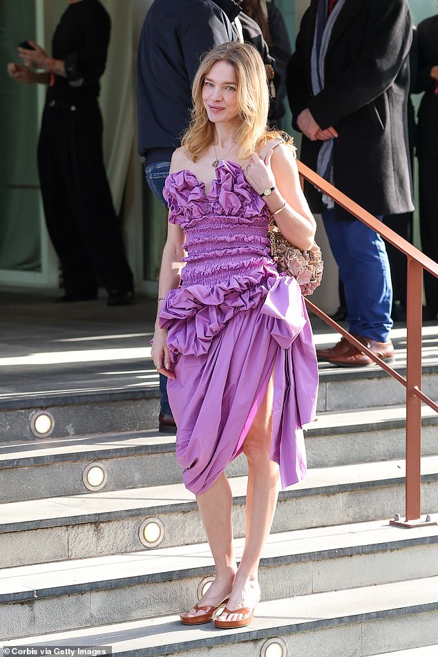 Model Natalia Vodianova wowed in an 80s inspired strapless purple strapless dress which had ruffles and ruching