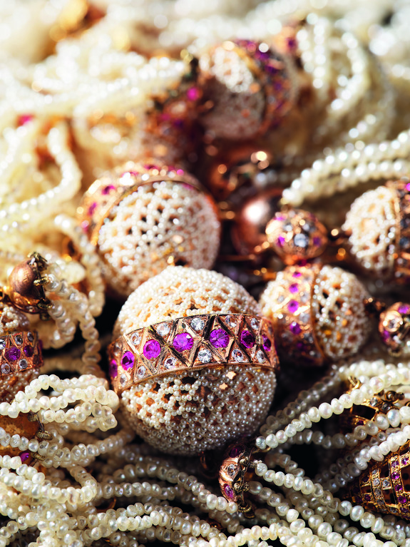 Intricately designed decorative balls with pearls and purple gemstones, showcasing exquisite craftsmanship and luxury.