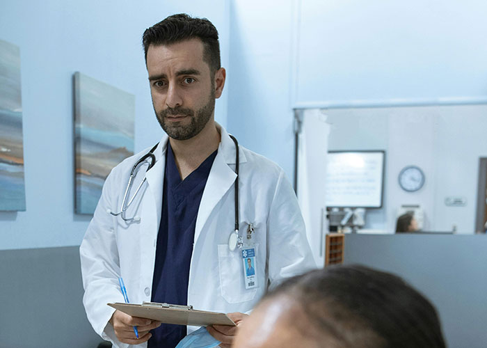 Doctor with stethoscope holding clipboard in medical clinic, revealing medical secrets that may cause fear.