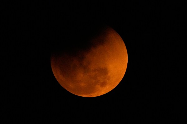 The blood moon is seen shortly after a total lunar eclipse in Guwahati, India, Tuesday, March 3, 2026. (AP Photo/Anupam Nath)