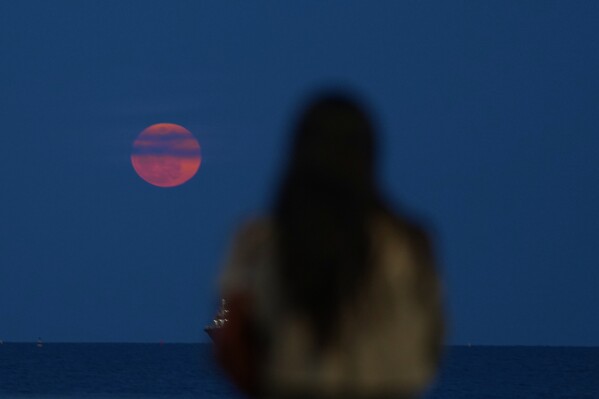The full moon rise over the Mediterranean sea in the southern city of Limassol, Cyprus, Tuesday, March 3, 2026. (AP Photo/Petros Karadjias)