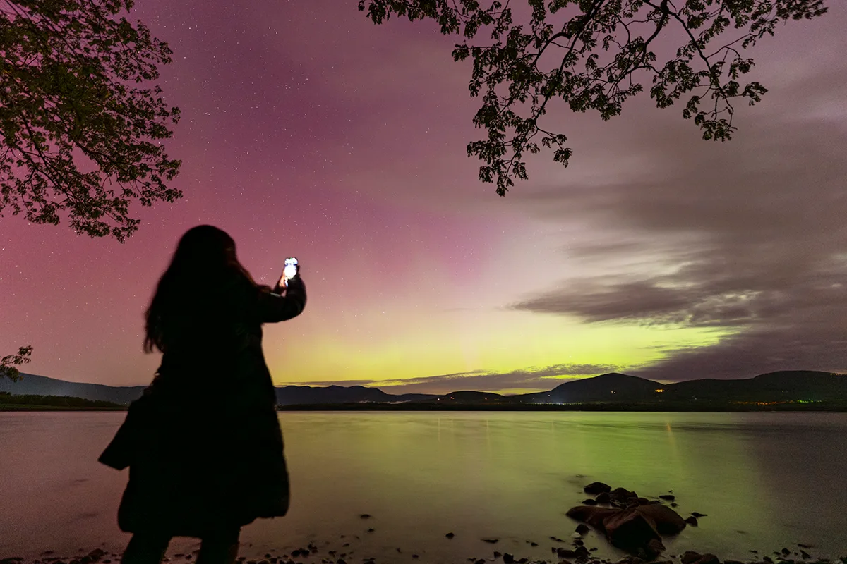 View of the aurora (and smartphone snapper) captured by Chirag Upreti from New York State, USA. Sony A7R3 camera, Sigma 14-24mm lens. Single exposure: ISO 800, 14mm, f/2.8, 10se