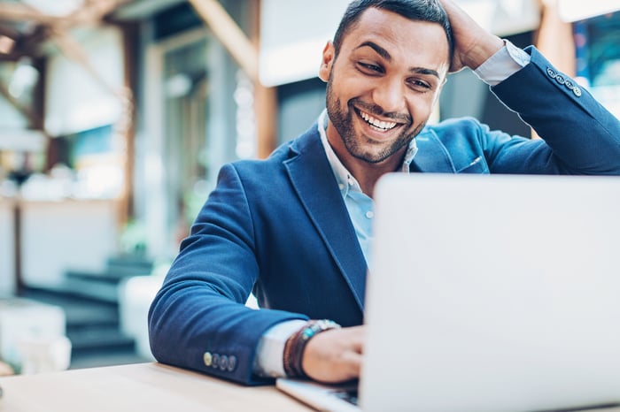An investor works on a laptop in an office.