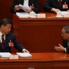 Chinese President Xi Jinping, left and Chinese Premier Li Qiang chat during the opening session of the National People's Congress (NPC) in Beijing, Thursday, March 5, 2026.