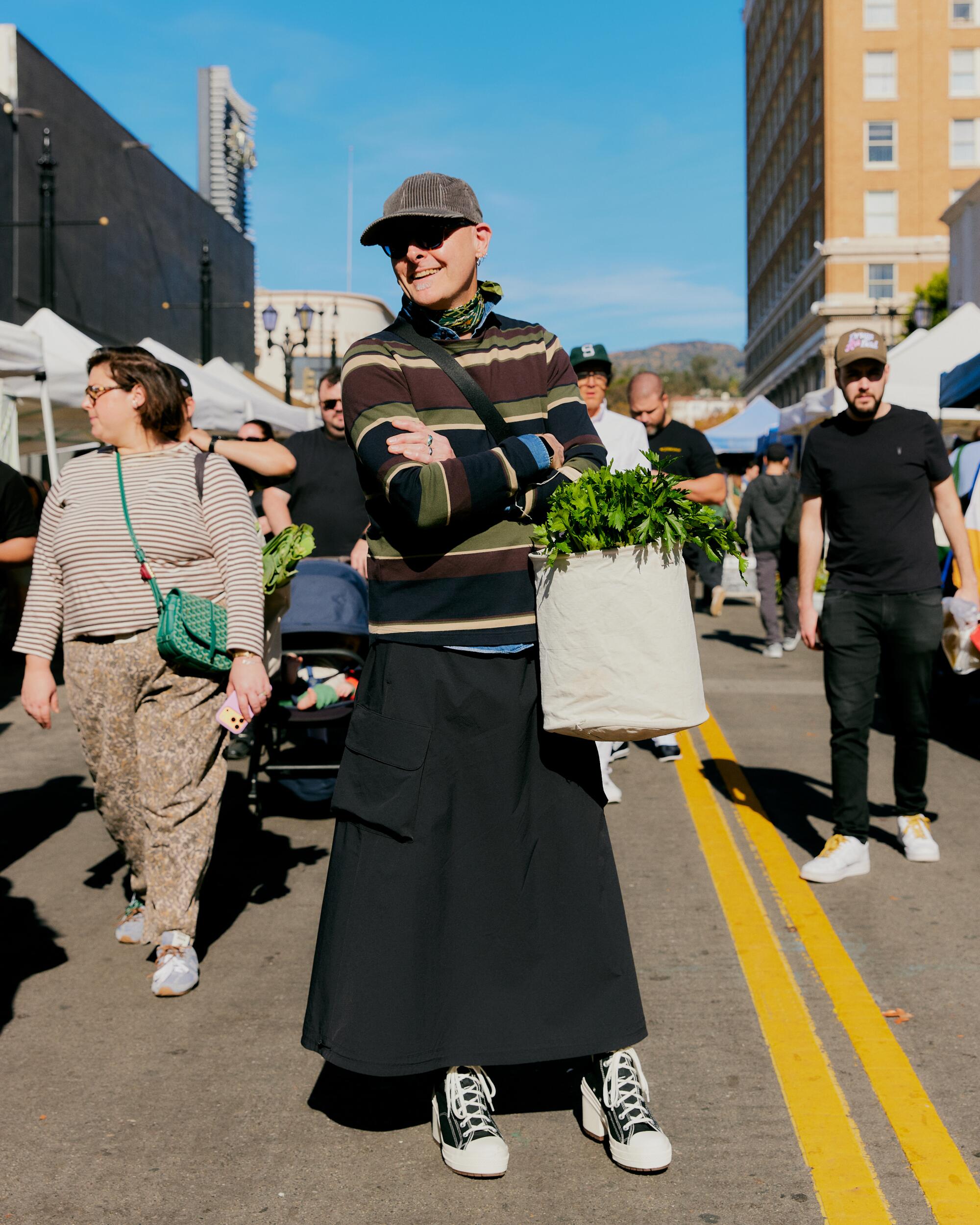 Cameron Crotty wears Liberty London sweater, Adidas skirt and Converse Chuck 70 De Luxe Heel High Top sneakers.