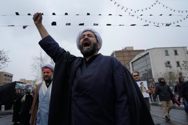 A cleric chants slogans during the annual anti-Israeli Quds Day, or Jerusalem Day rally in support of Palestinians in Tehran, Iran, Friday, March 13, 2026. (AP Photo/Vahid Salemi)