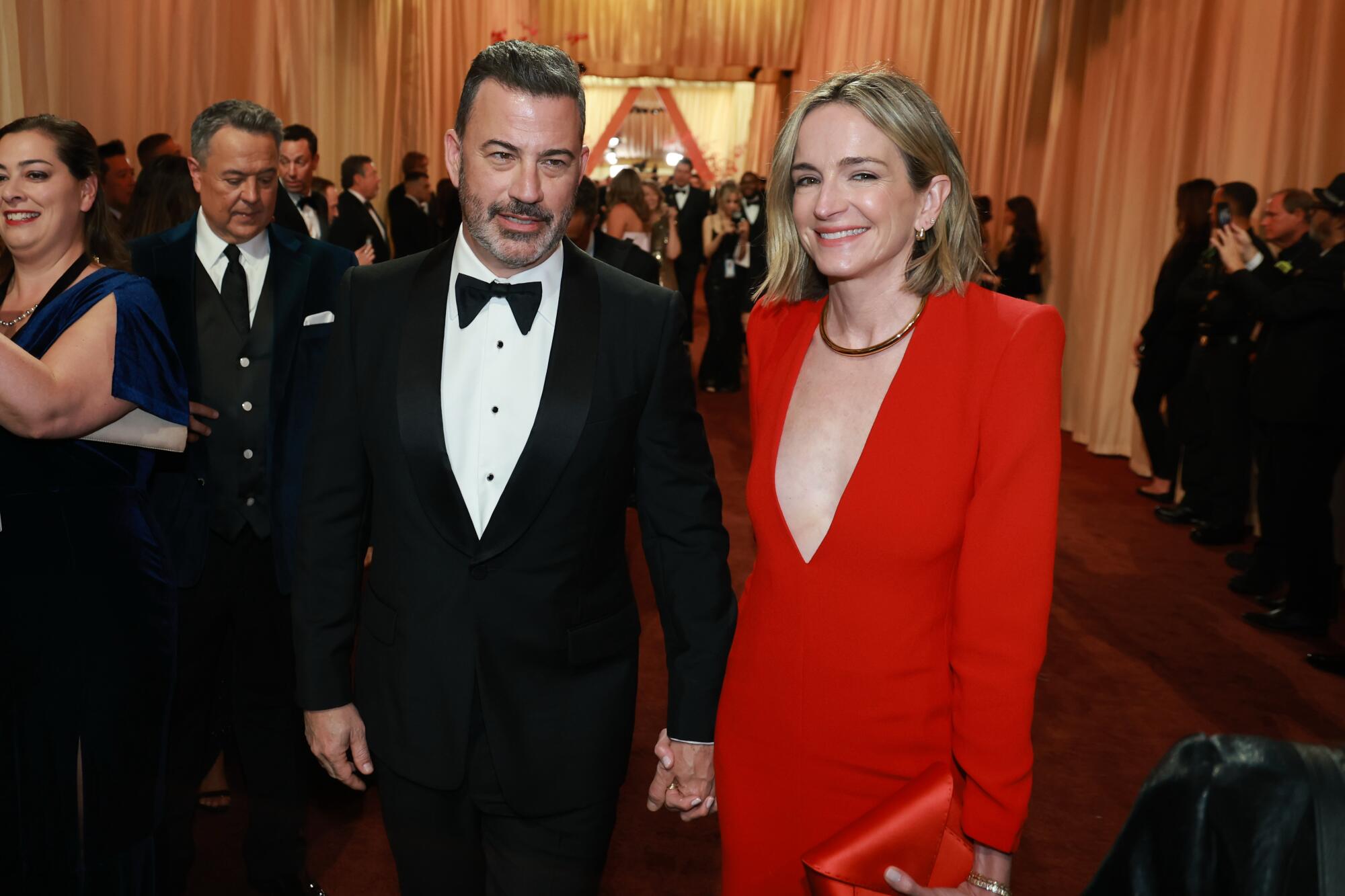 Jimmy Kimmel and Molly McNearney walk hand in hand. 